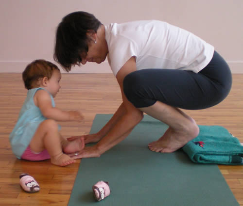 I use a blanket under my heels for stability.  When my shoulders are feeling OK I can wrap my arms around and grab my ankles.  Not today, though.